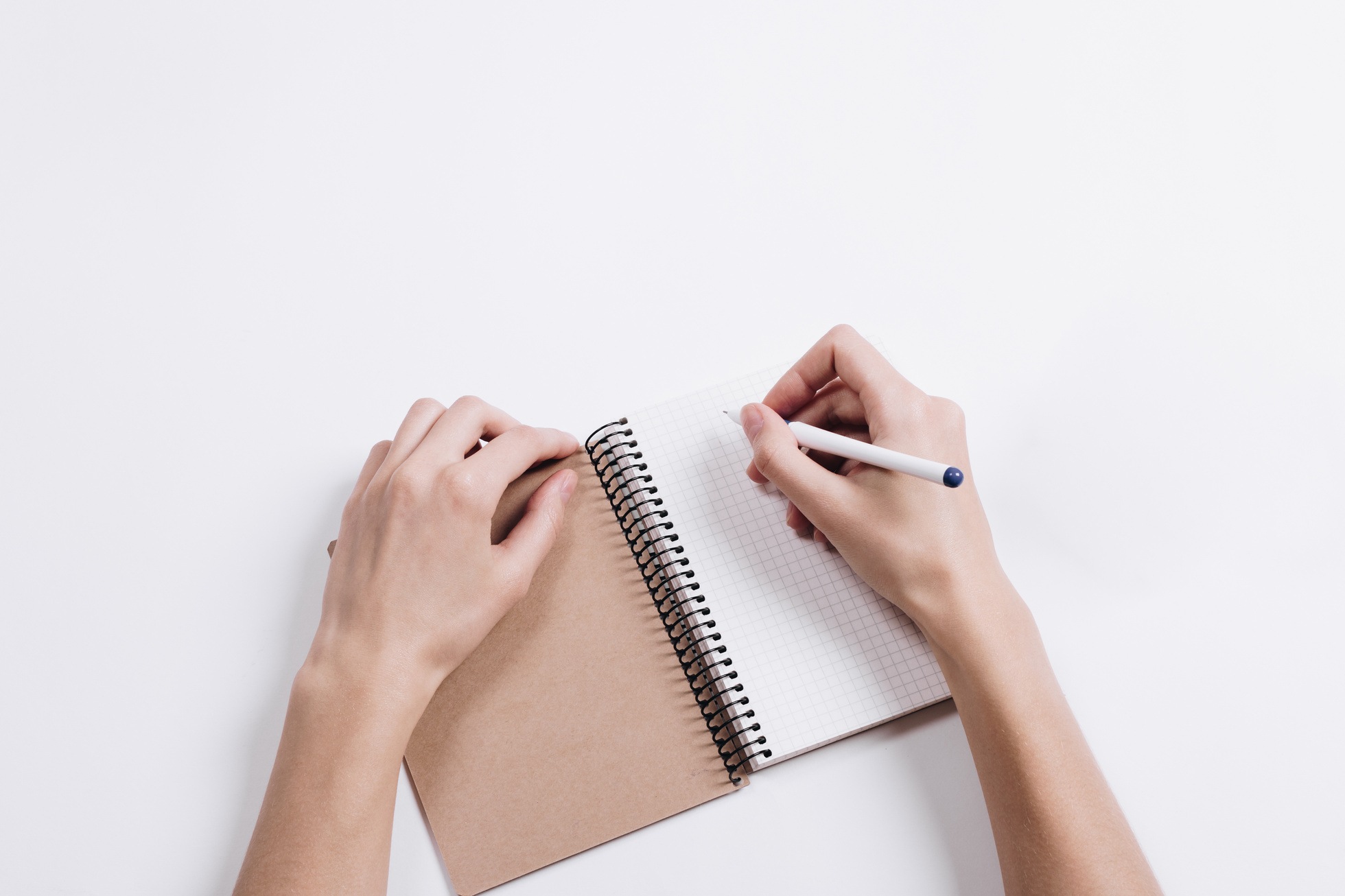 Close-up of Female Hands Writing in Notepad